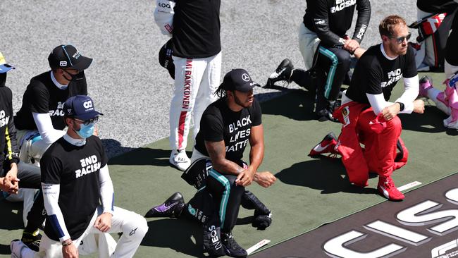 Lewis Hamilton (centre) and some of the F1 drivers take a knee. (Photo by Peter Fox/Getty Images)