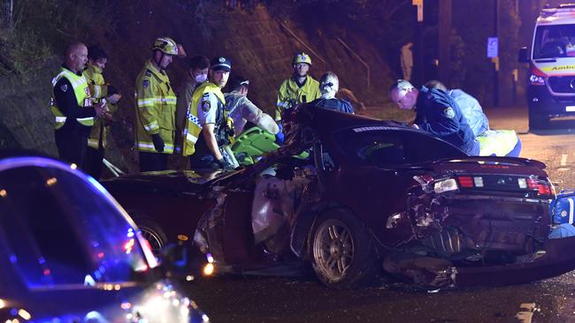 Crash investigators search wrecked vehicle. Picture: Gordon McComiskie