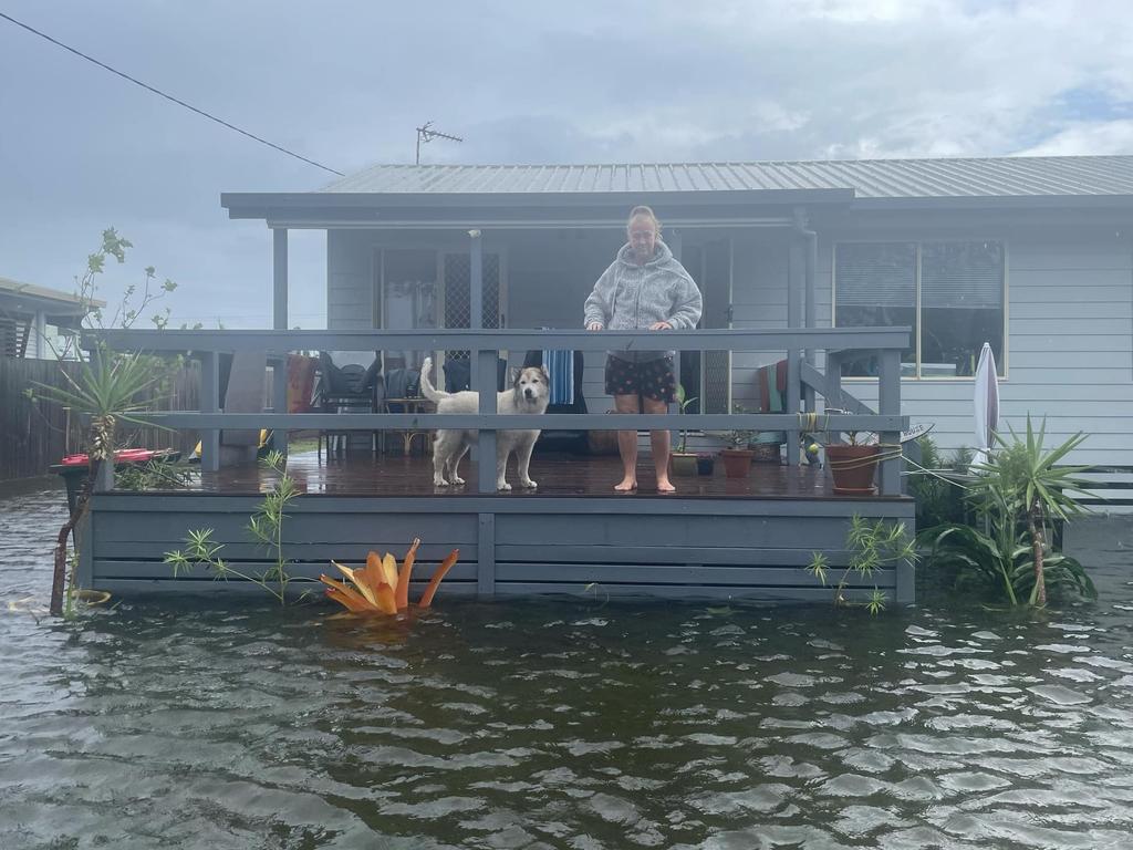 Yola Ashfield and her dog, Ruski, have been trapped in their home after water rushed into their yard. Picture: Phillip Fynes-Clinton