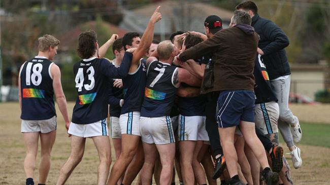 Players and fans rush to celebrate Kimpton’s milestone. Photo: Hamish Blair