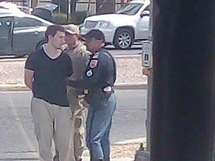 The alleged gunman is taken away after his arrest. Picture: Twitter