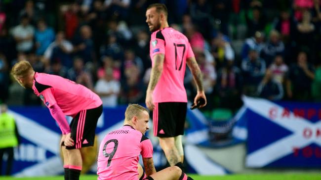 Scotland's players react after the draw