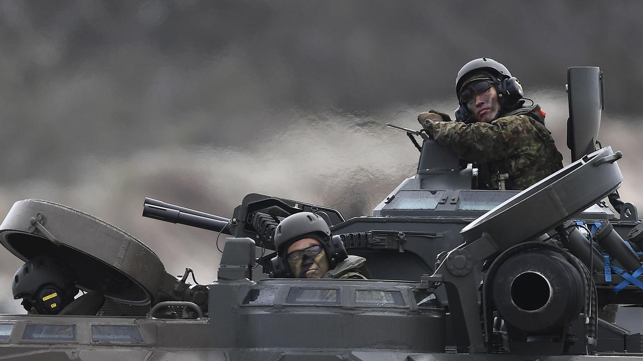 Japanese crew members look from their AAV (Assault Amphibious Vehicle) after completing a beach landing on July 22, 2019 in Bowen, Australia. Picture: Ian Hitchcock/Getty Images.