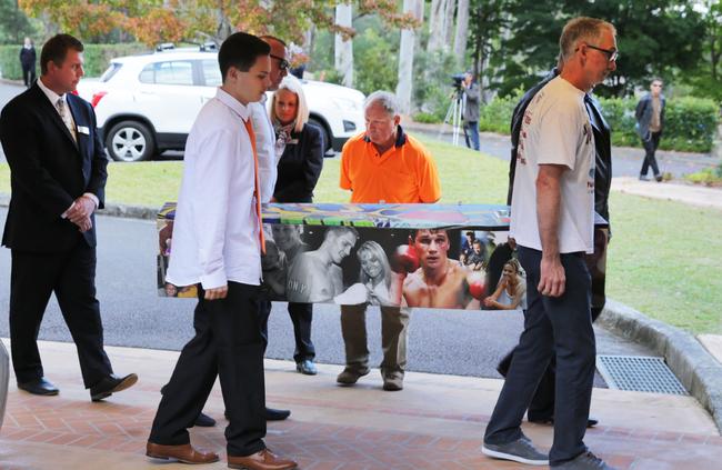 Mourners carry the coffin into the chapel at the funeral at Greenway Chapel and Memorial Gardens in Green Point. Picture: AAP Image/Mark Scott