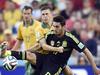 Spain's Koke, front, controls the ball under a challenge Australia's Matt McKay from during the group B World Cup soccer match between Australia and Spain at the Arena da Baixada in Curitiba, Brazil, Monday, June 23, 2014. (AP Photo/Martin Meissner)