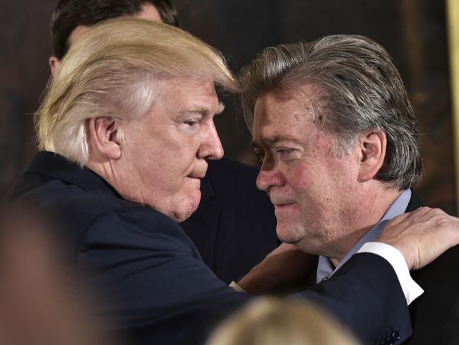 (FILES) This file photo taken on January 22, 2017 shows US President Donald Trump (L) congratulating Senior Counselor to the President Stephen Bannon during the swearing-in of senior staff in the East Room of the White House on January 22, 2017 in Washington, DC. Steve Bannon, President Donald Trump's chief strategist, has lost his seat on the powerful National Security Council on April 05, 2017 in an apparent high-level shakeup, a US official confirmed.  / AFP PHOTO / MANDEL NGAN