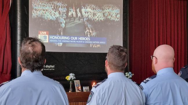 Queensland Police officers in the Tara Memorial Hall to watch the livestream of the Brisbane-based funeral for Tara Constables Rachel McCrow and Matthew Arnold who were killed in the line of duty.