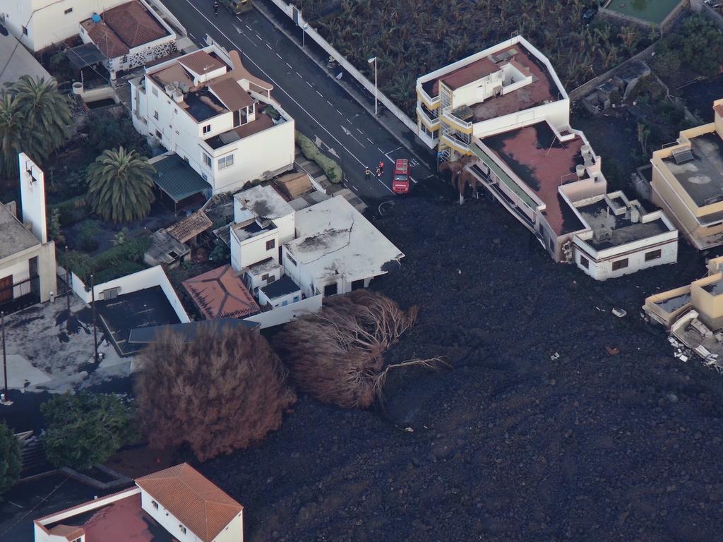 Houses and buildings partially covered by ash and cooled lava. Picture: EPA/Ticom Soluciones
