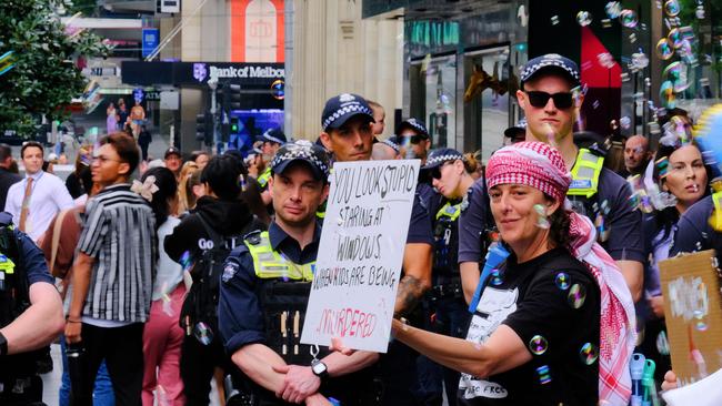 MELBOURNE AUSTRALIA - NewsWire Photos NOVEMBER 17, 2024: Pro-Palestinian protestors are seen along Bourke St Mall as retail giant Myer unveils its much-loved Christmas windows display.Picture: NewsWire / Luis Enrique Ascui