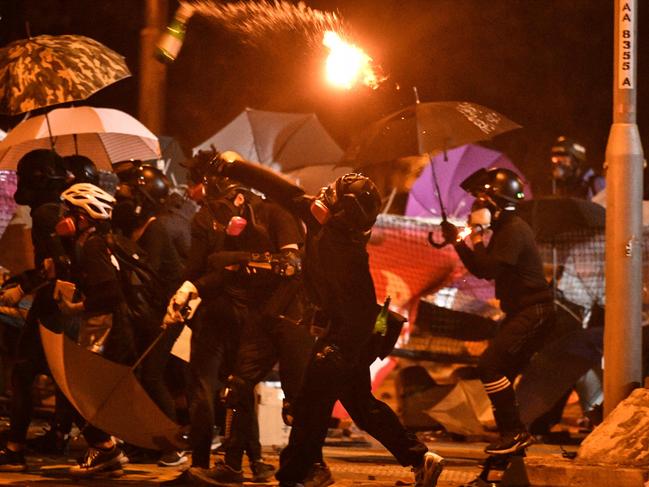 A protester throws a petrol bomb during clashes with police outside the Polytechnic University of Hong Kong. Picture: AFP