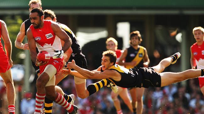 Richmond’s Mark Coughlan tries to bring a stop to Adam Goodes’ dominance.