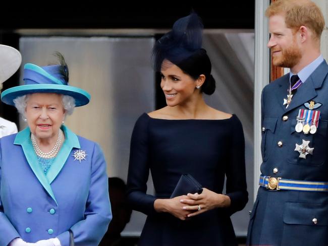 A rare appearance! Queen Elizabeth, left, with Meghan and Harry. Picture: AFP