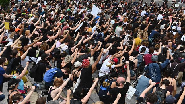 Protesters take a knee and raise their fists during a Black Lives Matter demonstration in front of the Brooklyn Library and Grand Army Plaza in Brooklyn, New York. Picture: AFP