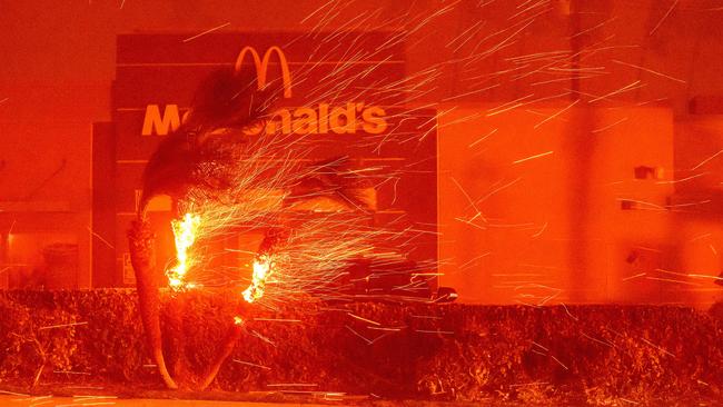 A McDonald's restaurant is showered in embers during the Eaton fire in Pasadena, California on January 7, 2025. Picture: Josh Edelson / AFP.