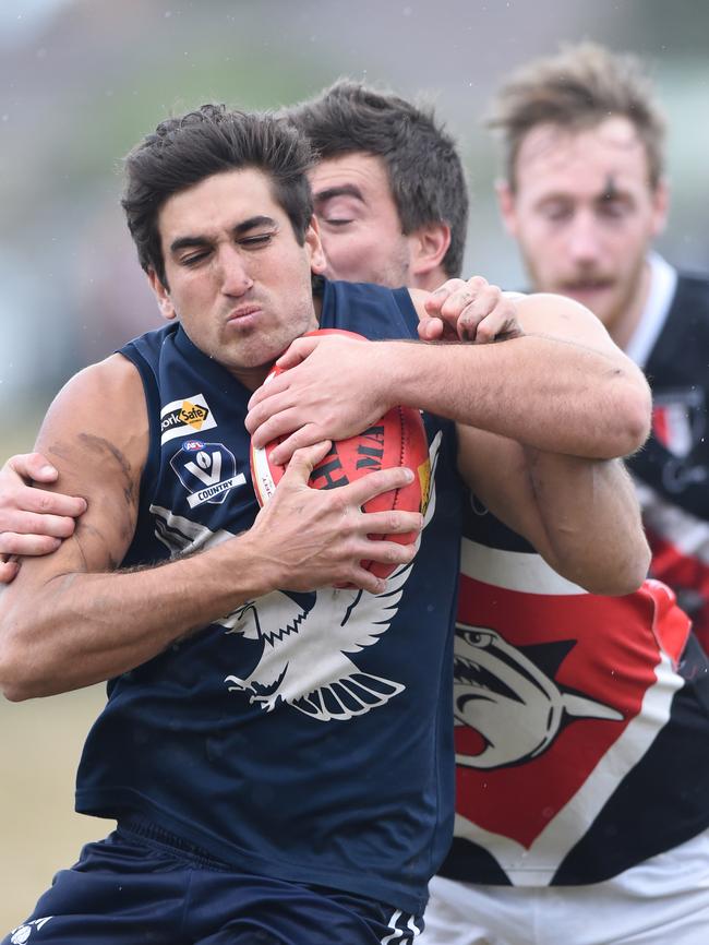 Edi-Asp’s Andrew Luxa tries to break through a tackle against Bonbeach. Picture: Chris Eastman