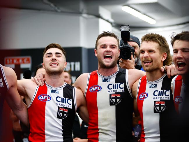 Jade Gresham, Brad Crouch and Dan Butler sing the song after a Saints win. Picture: Dylan Burns/AFL Photos via Getty Images.