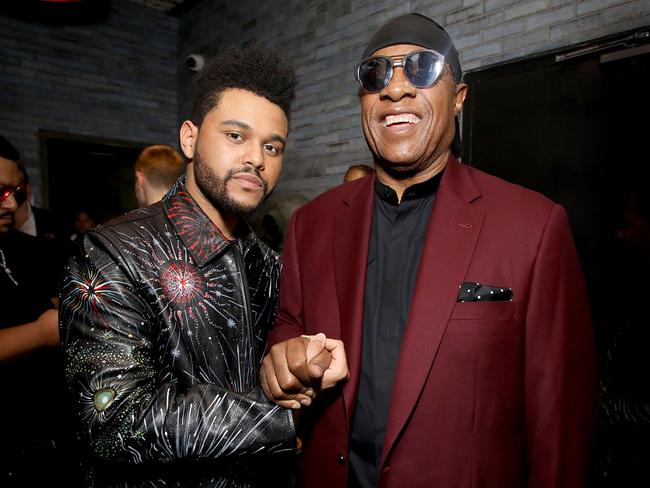 The Weeknd and Stevie Wonder celebrate at the Republic Records Grammy after-party. Picture: Getty