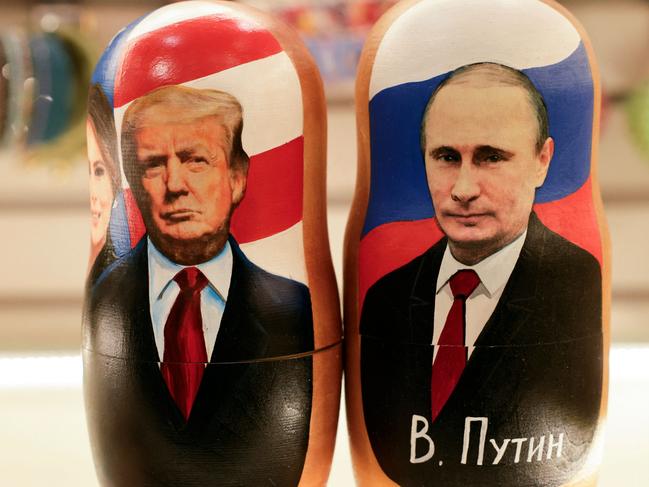 Traditional Russian wooden nesting dolls, Matryoshka dolls, depicting Russia's President Vladimir Putin (R), US President Donald Trump and his wife Melania (L) are displayed for sale at a gift shop on the touristic Arbat street in downtown Moscow on February 13, 2025. Russians were cautiously upbeat after Vladimir Putin and Donald Trump spoke by phone on February 13, 2025, praising it as a "first step" towards repairing ruptured ties between the two nuclear-armed superpowers. (Photo by TATYANA MAKEYEVA / AFP)