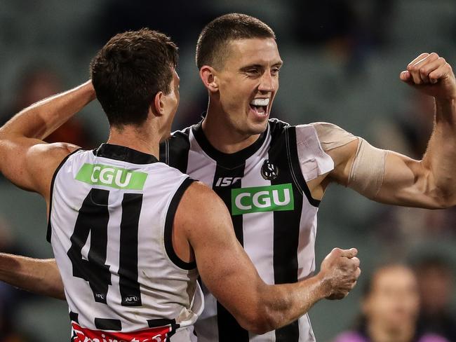 ADELAIDE, AUSTRALIA - AUGUST 11: Darcy Cameron of the Magpies celebrates a goal with team mate Brody Mihocek during the 2020 AFL Round 11 match between the Adelaide Crows and the Collingwood Magpies at Adelaide Oval on August 11, 2020 in Adelaide, Australia. (Photo by Matt Turner/AFL Photos via Getty Images)