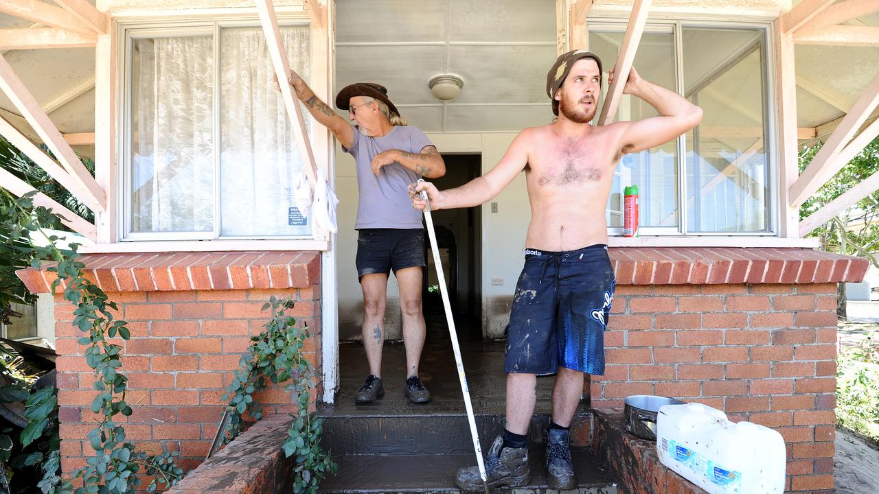 Two men clean up after flooding in Bundaberg, Saturday, Feb. 2, 2013. Residents of the hardest hit suburb in Queensland's flood crisis have begun the heartbreaking journey of returning home to assess damage after police opened the Burnett Bridge to north Bundaberg residents at 6am. (AAP Image/Paul Beutel) NO ARCHIVING