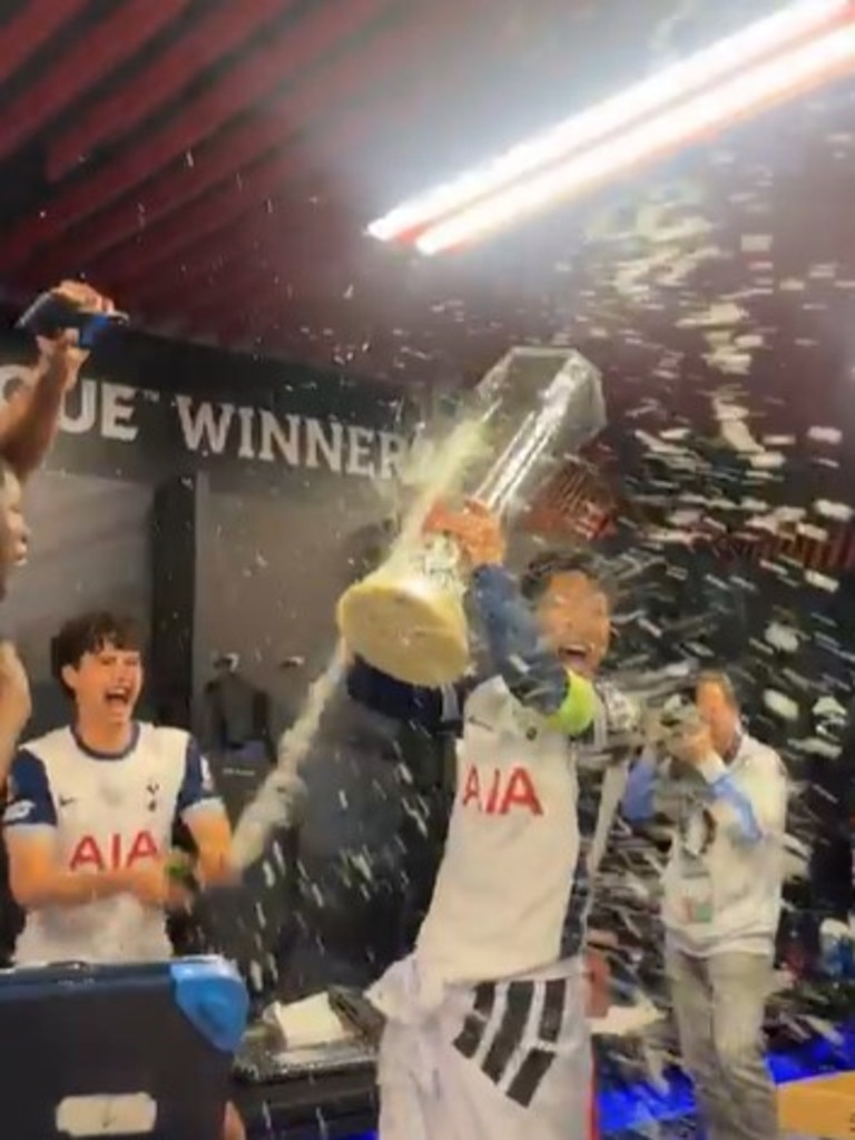 Tottenham captain Son Heung-min is showered with champagne by teammates.