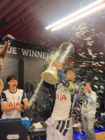 Tottenham captain Son Heung-min is showered with champagne by teammates.