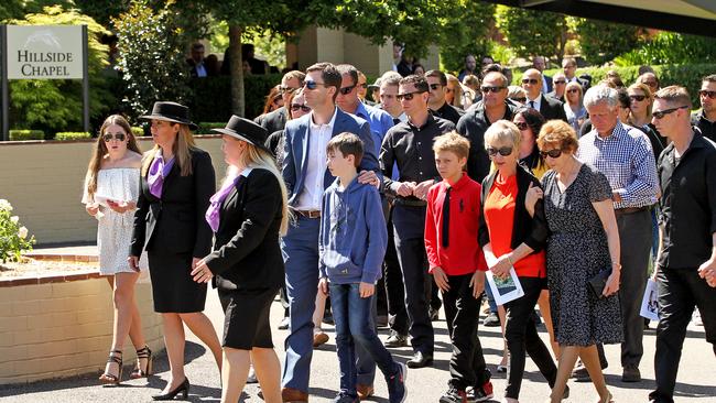 Family members leave the chapel after the funeral of Dreamworld victim Cindy Low.