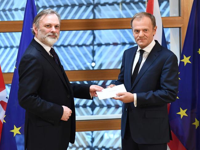 Britain's ambassador to the EU Tim Barrow (left) delivers British Prime Minister Theresa May's formal notice of the UK's intention to leave the bloc to European Council President Donald Tusk (right) in Brussels. Picture: AFP/Pool/Emmanuel Dunand