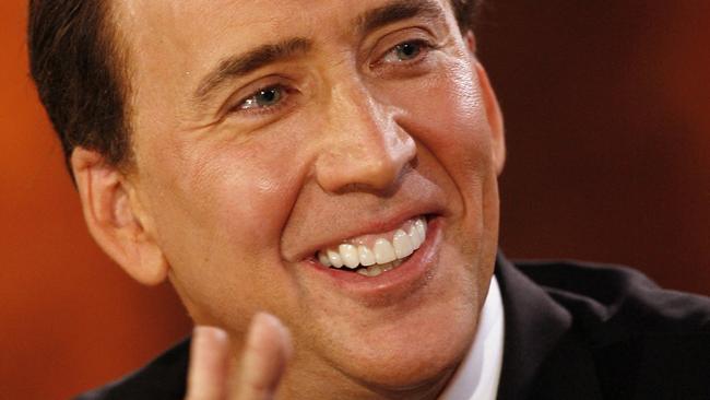 US actor Nicolas Cage applauds as he attends the TV show presented by German host Thomas Gottschalk (not pictured) 