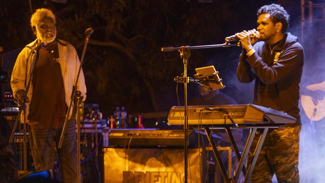 Mulka MLA Yingiya Mark Guyula joins nephew Terry Guyula on stage as Drifting Clouds performs at the 2024 Garma Festival. Picture: Peter Eve / Yothu Yindi Foundation.