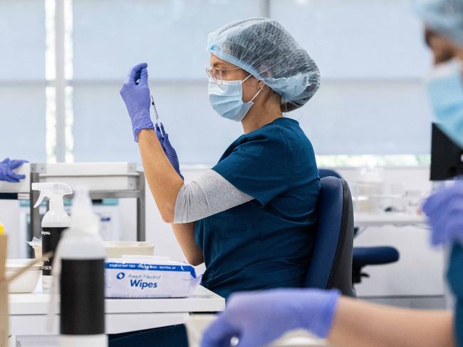 SYDNEY, AUSTRALIA - NewsWire Photos May 10, 2021:  Staff preparing vaccines in the pharmacy area of the NSW Vaccination Centre in Homebush, Sydney.Picture: NCA NewsWire / James Gourley  - POOL via NCA NewsWire