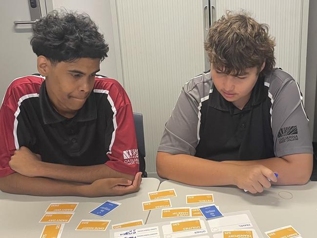 Casuarina Senior College and Clontarf Foundation students Nathaniel and Jack learn to 'budget like a boss' with the help of Bank of Queensland Qld and NSW state manager Ross Gillam.