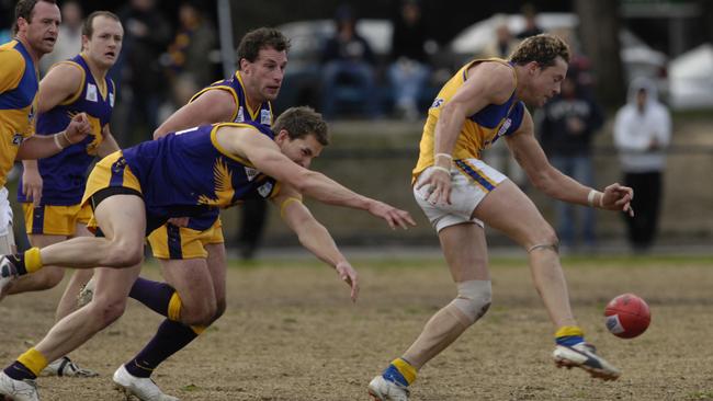 Kris Barlow gets a kick away for Noble Park against his old club Vermont.