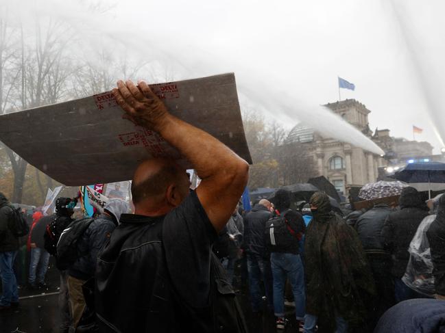 Anti-lockdown protesters with posters saying ‘Leipzig doesn’t need lateral thinkers’ in Leipzig, Germany, over the weekend. Picture: Getty Images