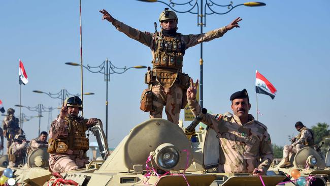 Soldiers commemorate the defeat of IS in the northern Iraqi city of Mosul. Picture: AFP