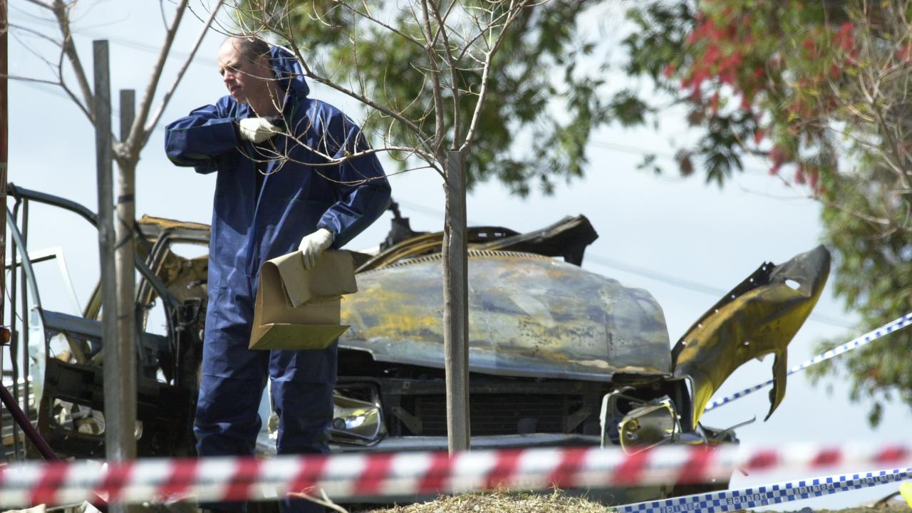 Police forensic squad officers at the scene of a car bomb which killed Don Hancock and Lou Lewis.