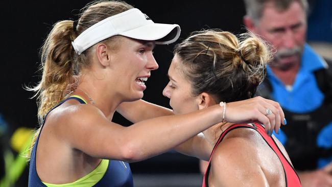 Caroline Wozniacki and Simona Halep embrace after the match. Picture: AFP Photo