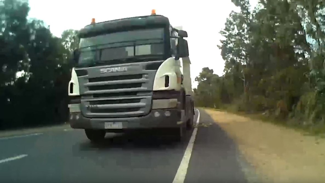 A truck passes dangerously close to a cyclist who is riding in a designated bike lane. Picture: Cycliq