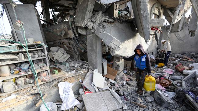 People inspect damage and recover items from their homes following Israeli air strikes on Rafah this week, Picture: Getty Images