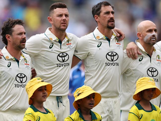 PERTH, AUSTRALIA - NOVEMBER 22: Travis Head, Josh Hazlewood, Mitchell Starc and Nathan Lyon of Australia sing the national anthem ahead of day one of the First Test match in the series between Australia and India at Perth Stadium on November 22, 2024 in Perth, Australia. (Photo by Cameron Spencer/Getty Images)