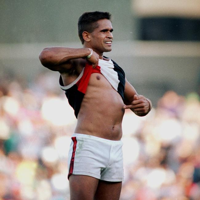 Nicky Winmar lifts his jumper and points to the colour of his skin to the Collingwood supporters at Victoria Park in 1993.