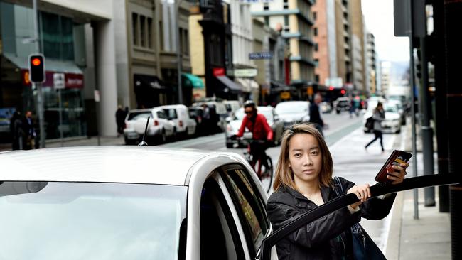 08/09/15 News limited reporterJosephine Lim is testing out an Uber ride . Pictured with the Uber car, driver didn't want him or his vehicle identified. Picture Roy VanDerVegt