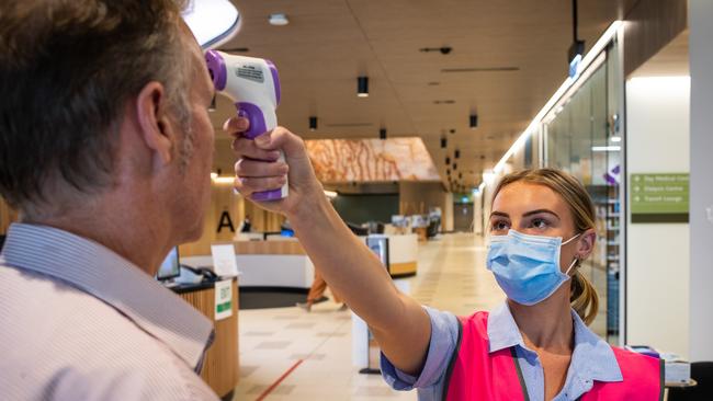 Nurse Grace Heidke taking the temperatures of everyone arriving at Northern Beaches Hospital in Frenchs Forest in April. Picture: Julian Andrews