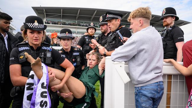 An animal rebellion activist is arrested after running onto the racecourse, on day two of the Epsom Derby. Picture: Getty.