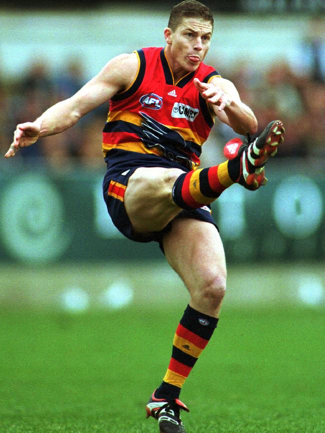 Crows captain Mark Bickley gets a kick away during a match against Carlton in 2000.