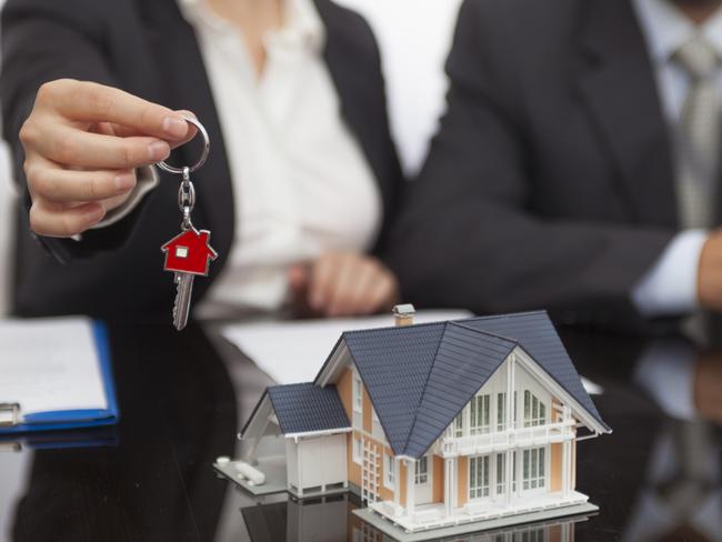 Female real estate agent giving the house key