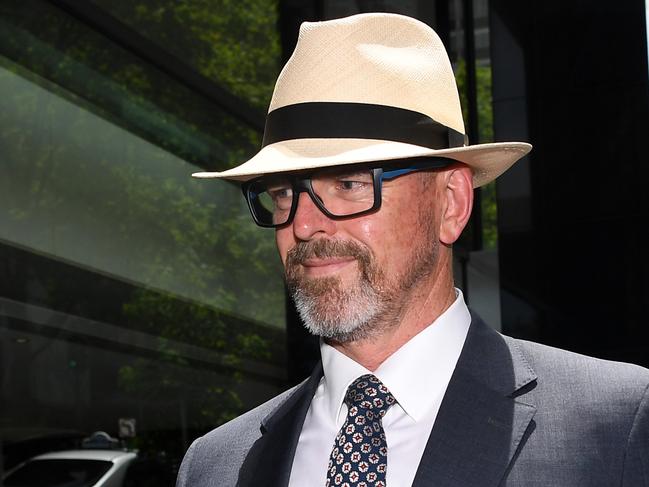 Former Victoria Police Chief Commissioner Simon Overland (left) arrives to the Royal Commission into the Management of Police Informants at the Fair Work Commission in Melbourne, Wednesday, December 18, 2019. (AAP Image/James Ross) NO ARCHIVING