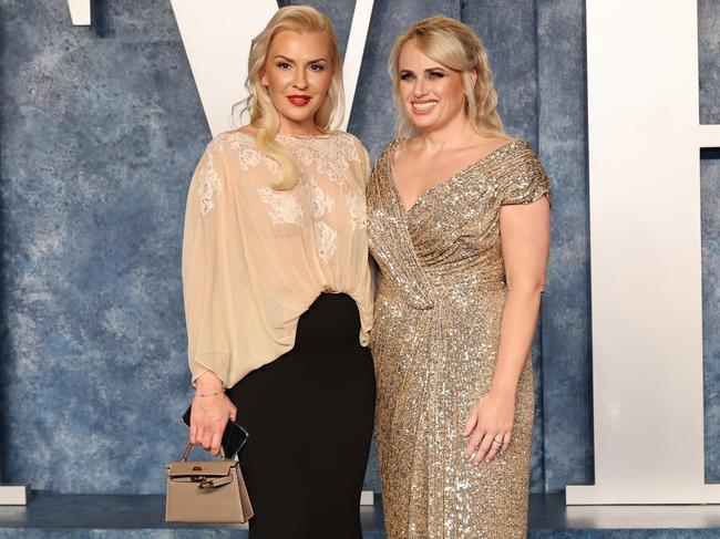 Write time to tell her story … Rebel Wilson, pictured with fiancee Ramona Agruma at the 2023 Vanity Fair Oscar Party, says her memoir will have plenty of laughs along the way.