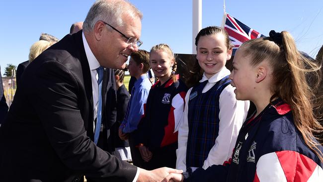 Scott Morrison is greeted by primary school students at the Western Sydney International Experience Centre in western Sydney on Monday. Picture: AAP