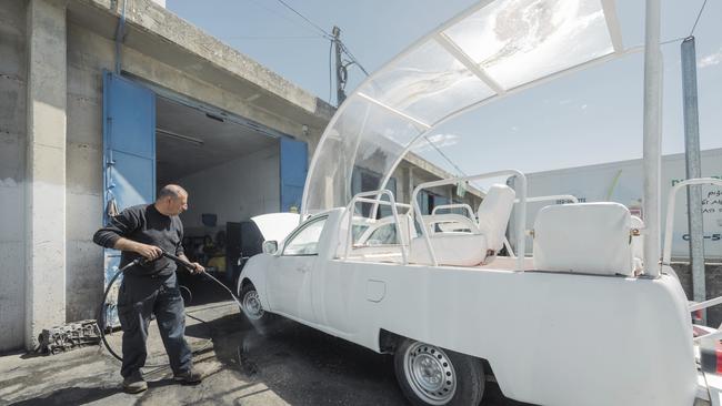 Photo released by Caritas Jerusalem a man washes a popemobile donated by late Pope Francis before his death to be converted into a mobile health unit to serve the children of Gaza. Picture: Caritas Jerusalem